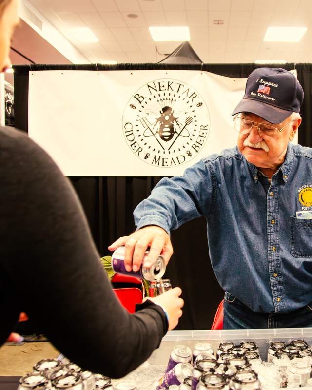 man pouring beer into glass for attendee of Mountain west beer festival in rapid city, sd