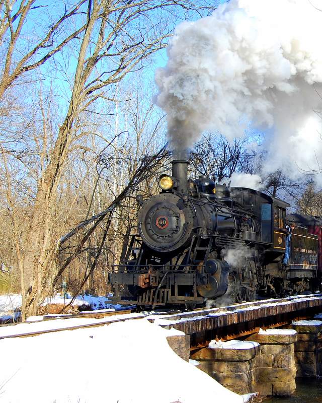 New Hope Ivyland Railroad train moving along tracks with snow on the ground