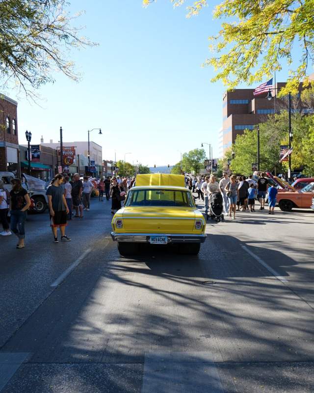 classic cars and people walking the streets of downtown rapid city during the cruiser car show event