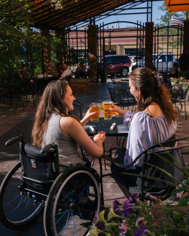 Two women touching beer glasses at Thirstys in Rapid City South Dakota