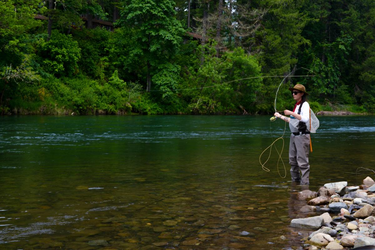 Woman Fly Fishing on the McKenzie River by Melanie Griffin