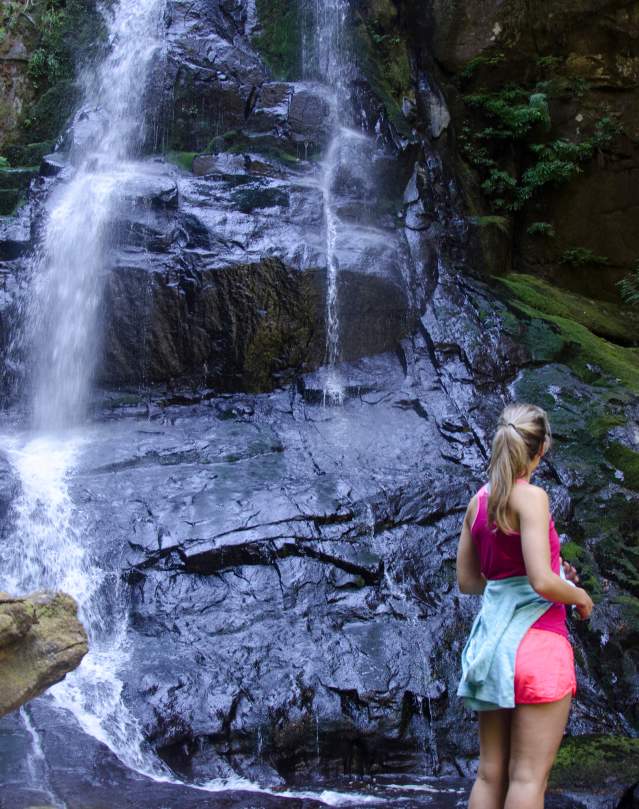 Girl viewing waterfall in summer