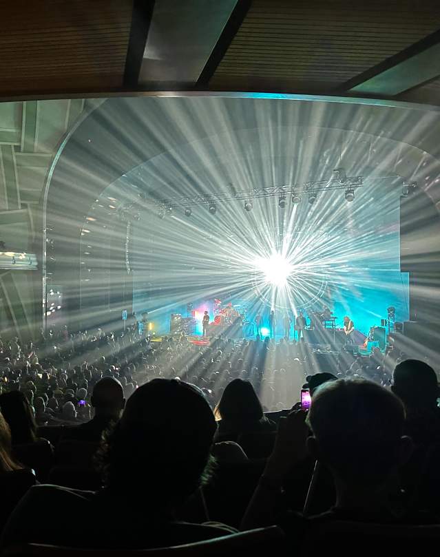 Lights shine out from stage with audience silhouetted - Australian Pink Floyd live at Hult Center