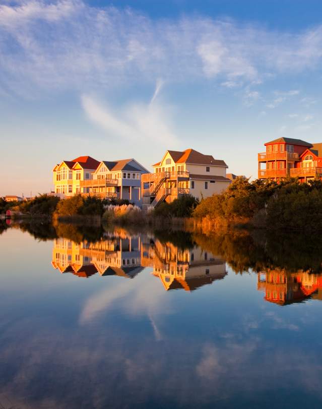 Homes sit on the water's edge, granting their occupants the best Outer Banks sunset views.