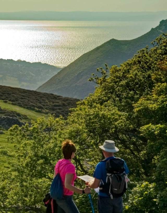 View of two walkers looking out over Sychnant Pass