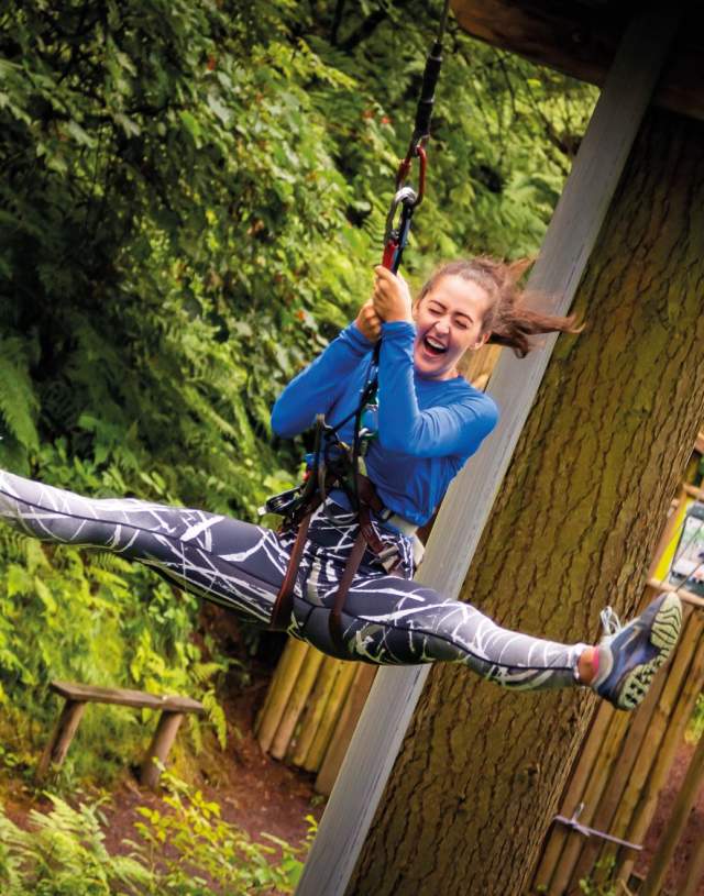 A girl enjoy a zipwire challenge at Go Ape