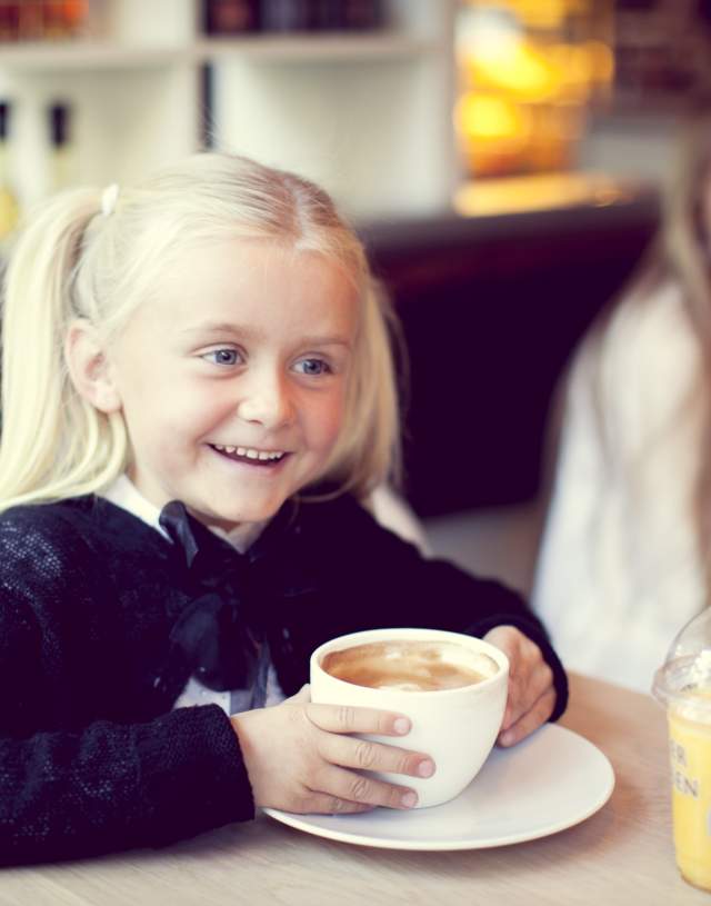 Girl enjoying hot chocolate at a cafe in Hønefoss