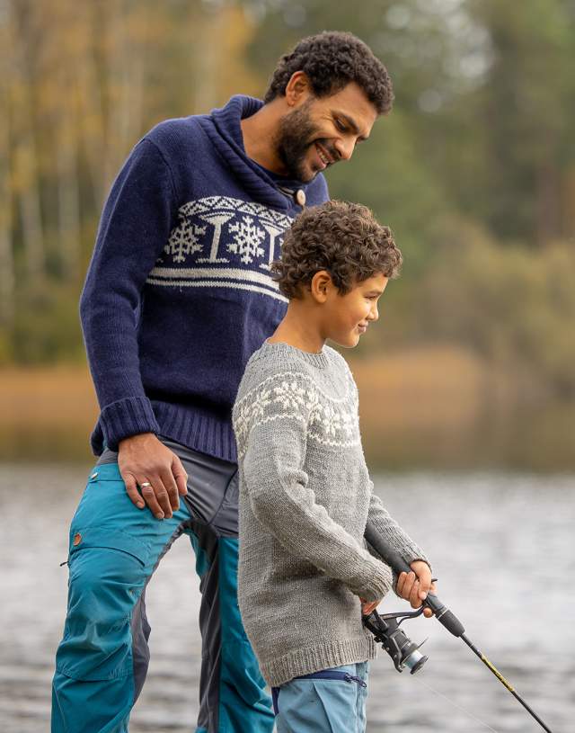 Man and boy fishing by a lake