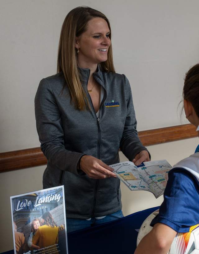 LSC representative presenting information to two young athletes