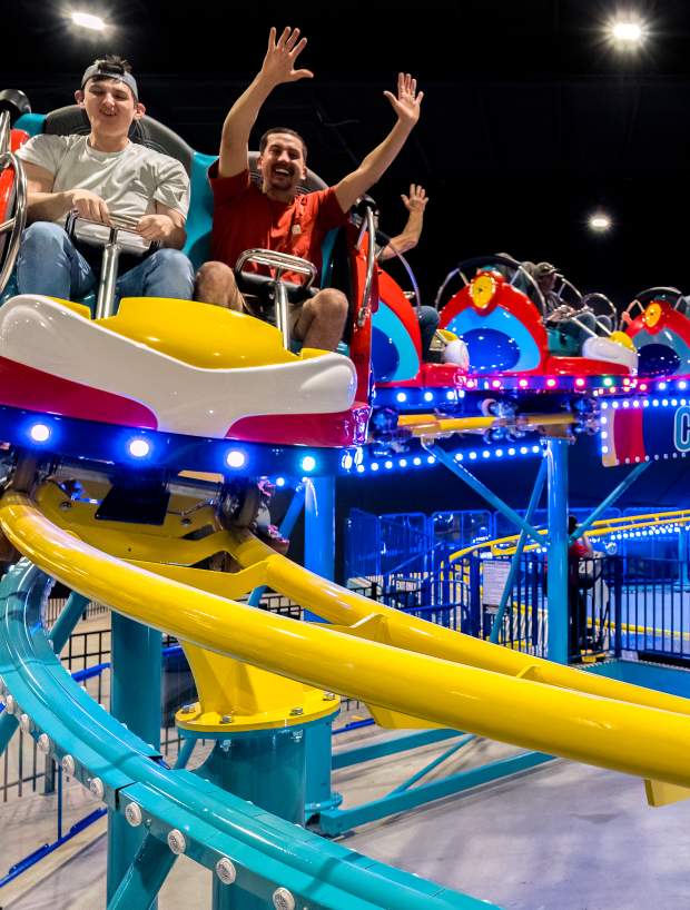 family on an indoor roller coaster