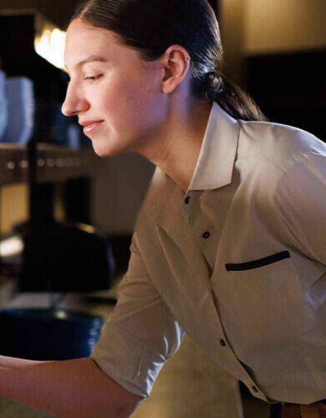 Restaurant worker pushing plated food out