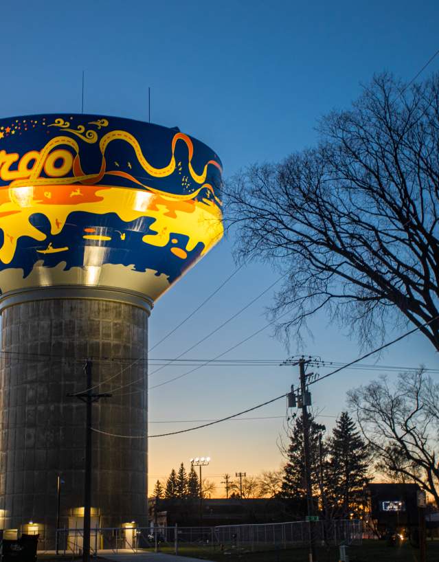 Fargo Water Tower lit up at dusk.