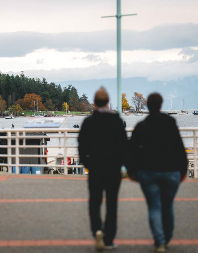 Two people walking on the Nanaimo waterfront.