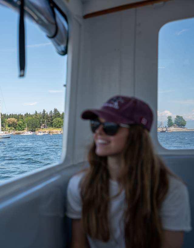 A person looking out of the window of a ferry.