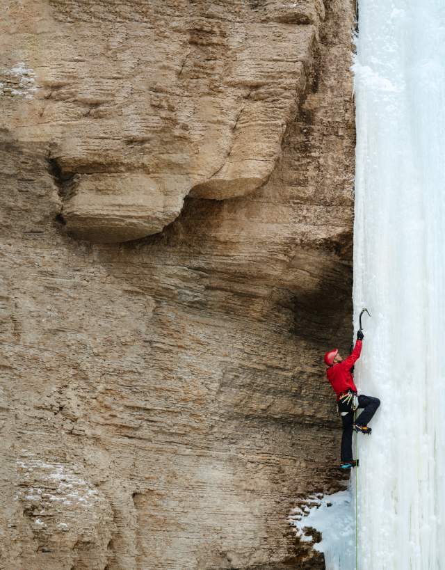 Aaron Mulkey climbing a frozen waterfall