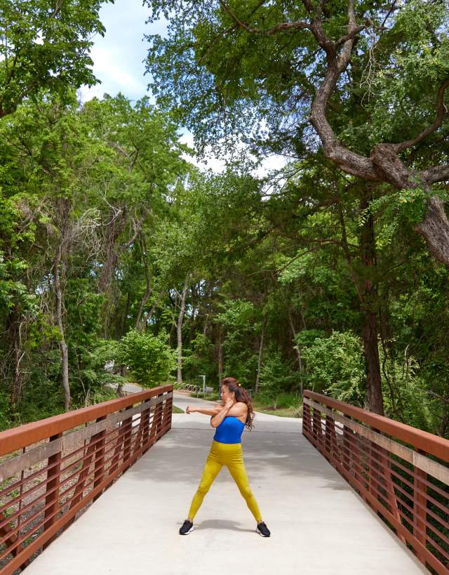 senior stretching on bridge