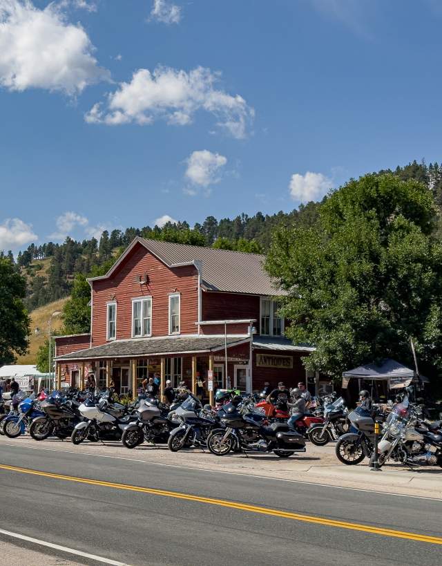 Motorcycles parked in front of a store along the side of a road near Hulett Wyoming.