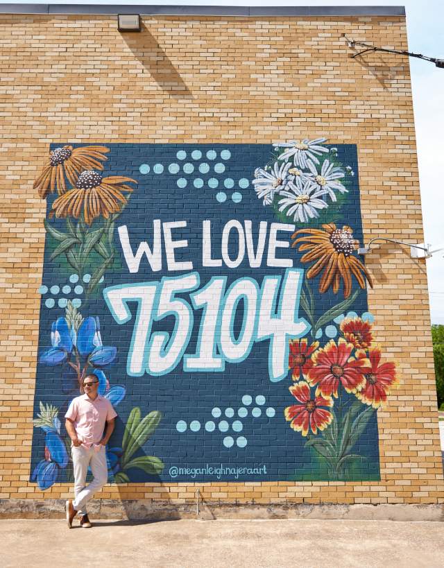 man in front of mural in downtown