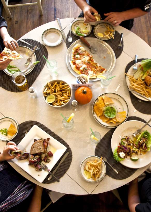 Aerial view of people sitting and eating at a restaurant