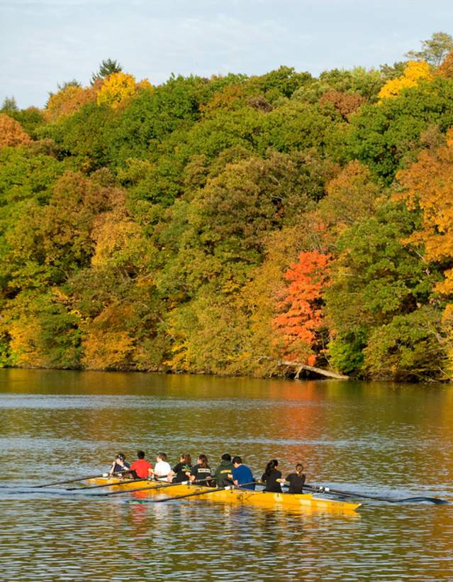 Regatta boat going down Hurin River in the fall