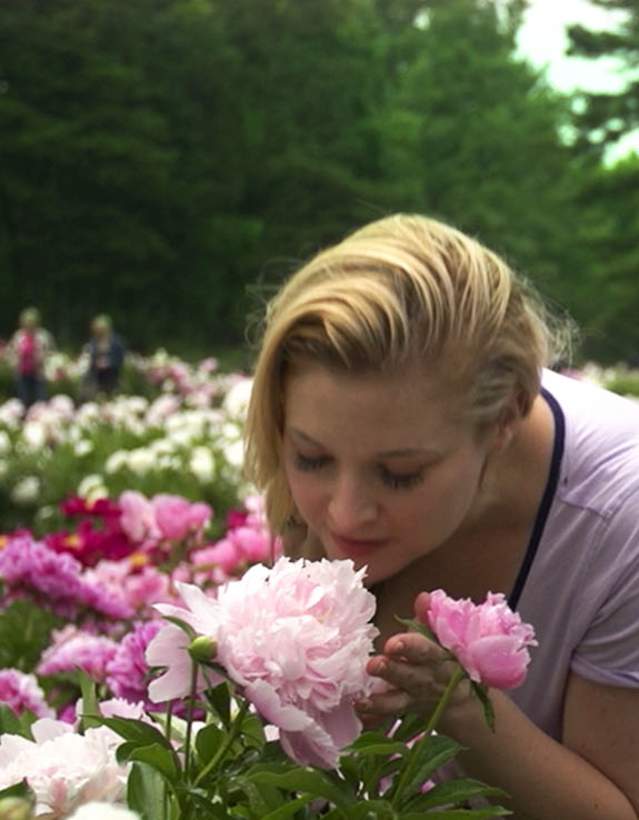 Woman smelling a peony
