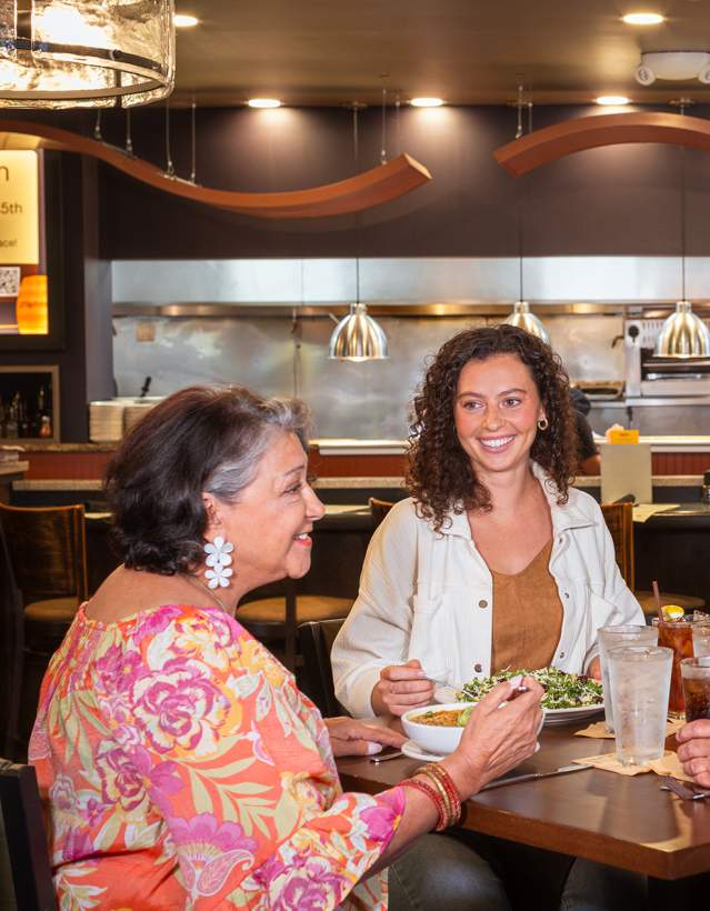 Two couples from different generations eating at Zingerman's Roadhouse