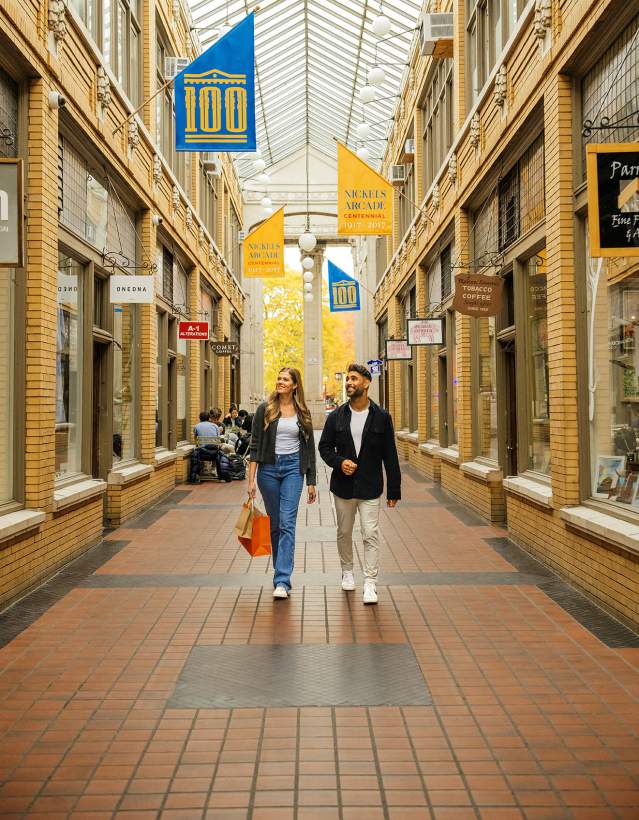 Young couple walking through covered outdoor walkway