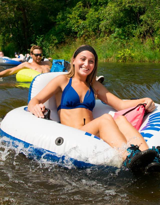 Woman tubing down Argo Cascades