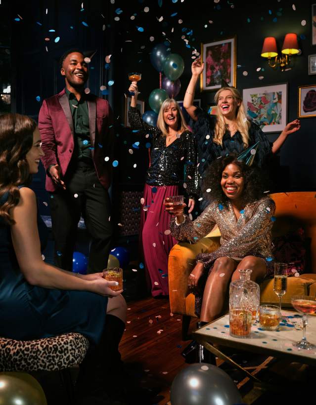 Hands raised with champagne glasses on New Years Eve