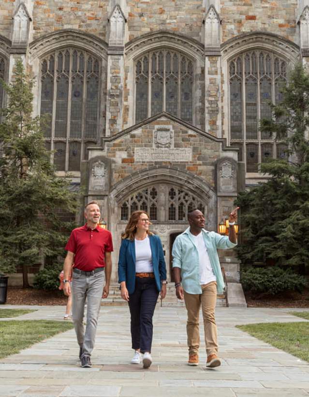 Group of three adults walking through U-M Law Quad