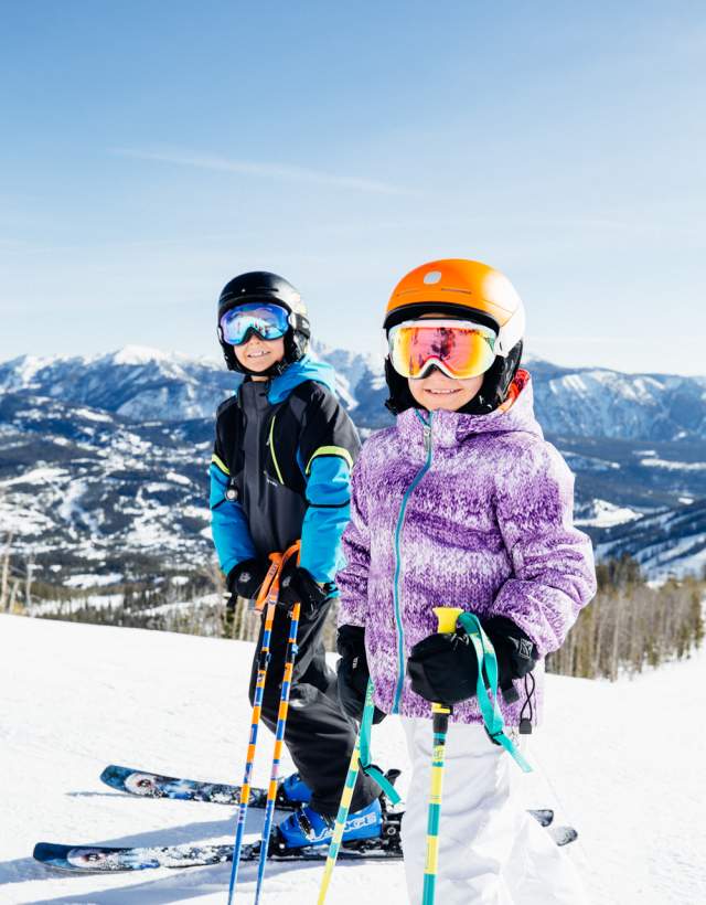 A young boy and girl on the slopes at Big Sky Resort