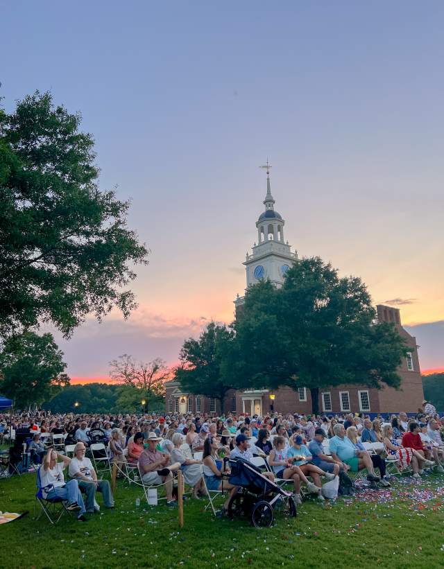 A crowd of people waits for fireworks at the American Village Independence Day Festival.