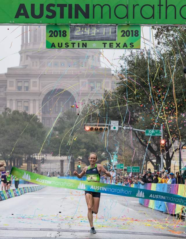 Runner crosses the finish line at the Austin Marathon in austin texas