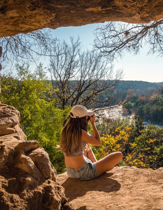 woman sitting on overlook at greenbelt in Austin Texas