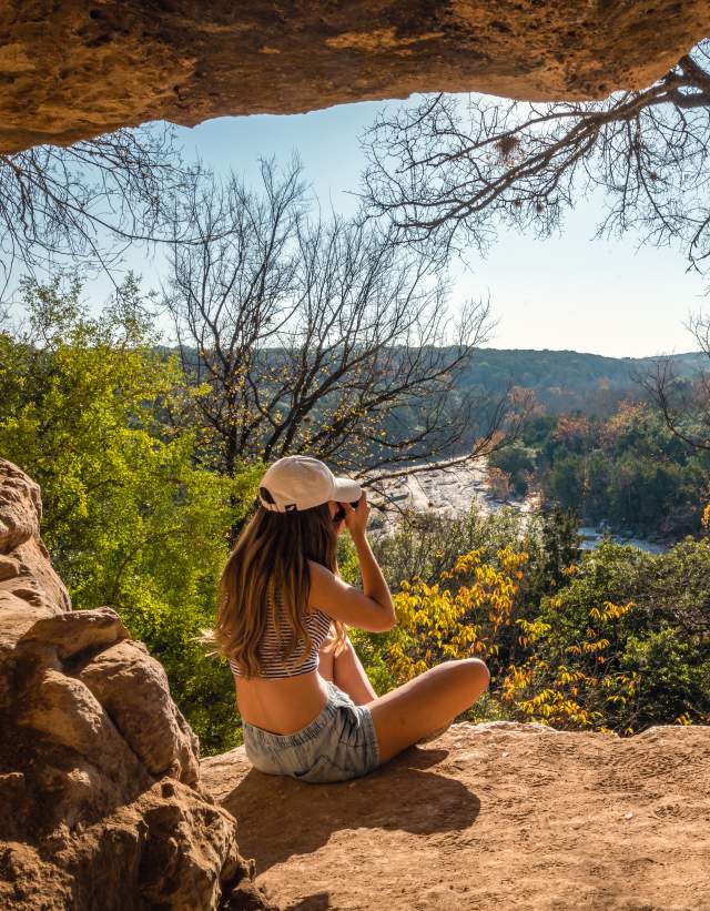 woman sitting on overlook at greenbelt in Austin Texas