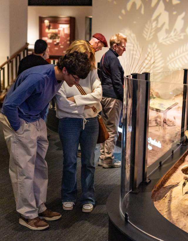 People looking at a fossil exhibit at the Texas Science & Natural History Museum.