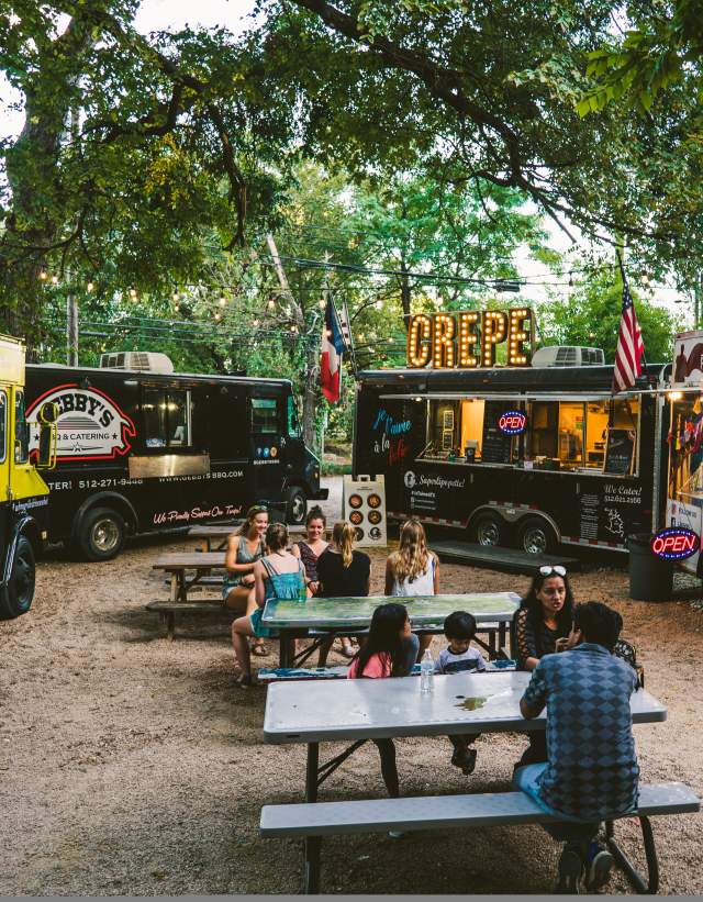 People dining near food trailors at the Rainey Street Food Truck park