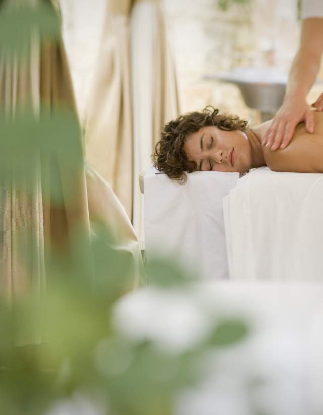 Woman receives massage in Outdoor Treatment Space at Lake Austin Spa Resort in Austin Texas