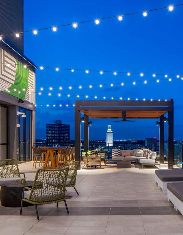 Rooftop patio of Hilton Garden Inn University Capitol District complete with fire pits, string lights and eclectic mural.