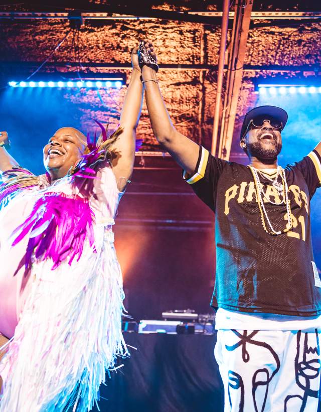 Riders Against the Storm holding hands in the air on stage