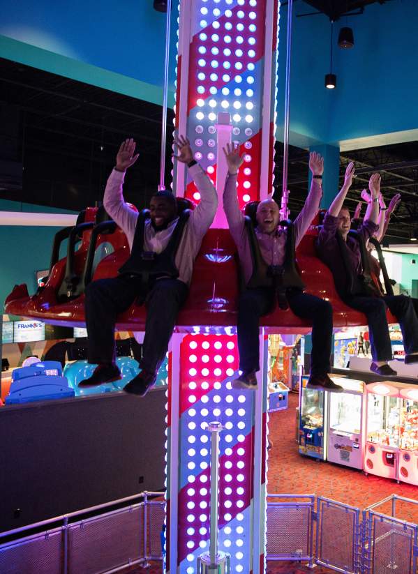 interior drop zone, neon lights, arcade, hands in the air