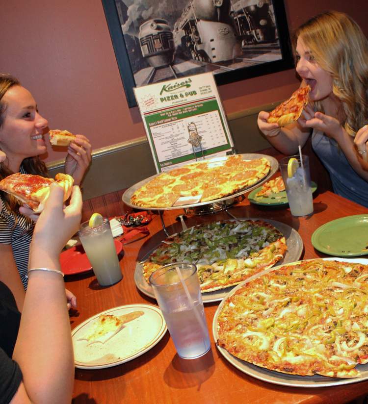 Ladies eating pizza at Kaiser's