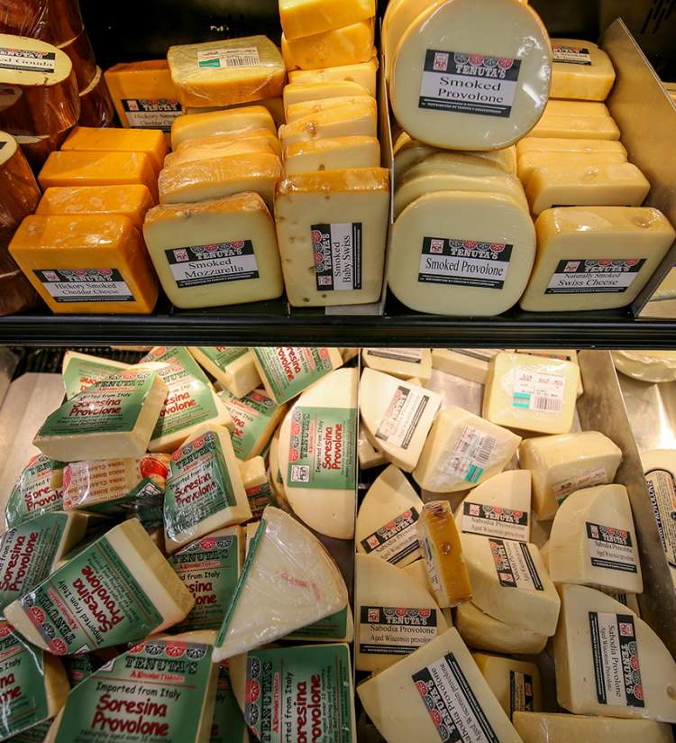 Tenuta's Deli in Kenosha offering an array of different cheeses, including smoked gouda, hickory smoked cheddar, smoked mozzarella, smoked baby swiss, smoked provolone, and naturally smoked swiss cheese.