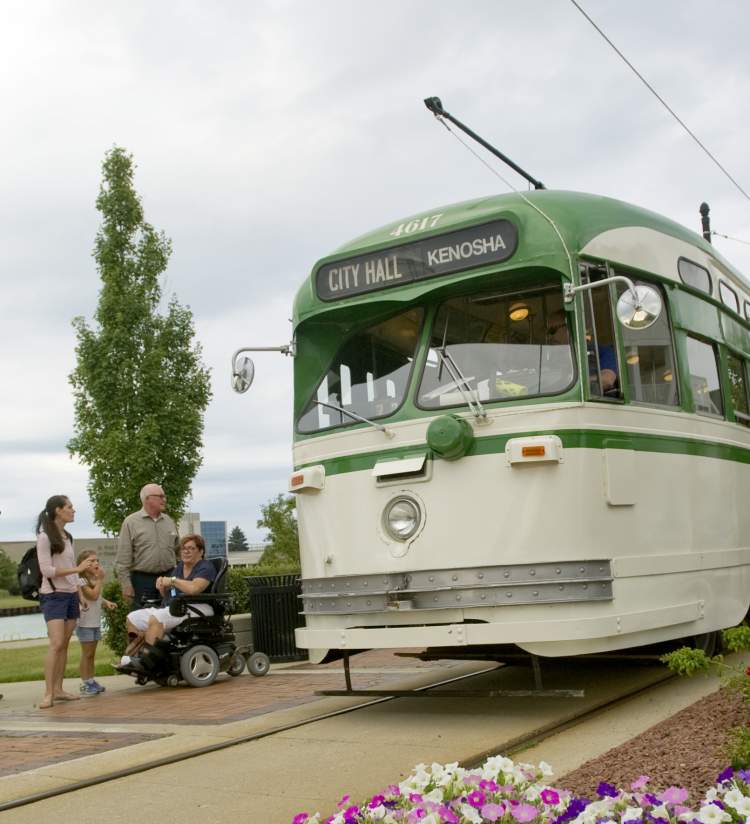 Streetcar with multi-generational family, kids, wheelchair, flowers