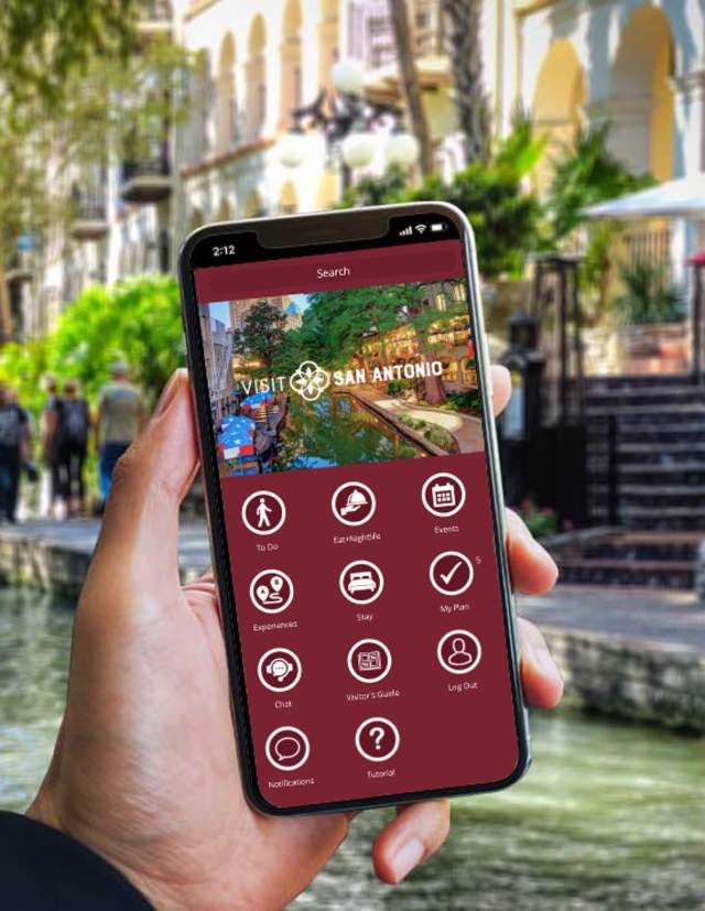 Hand holding a phone with the Visit San Antonio App