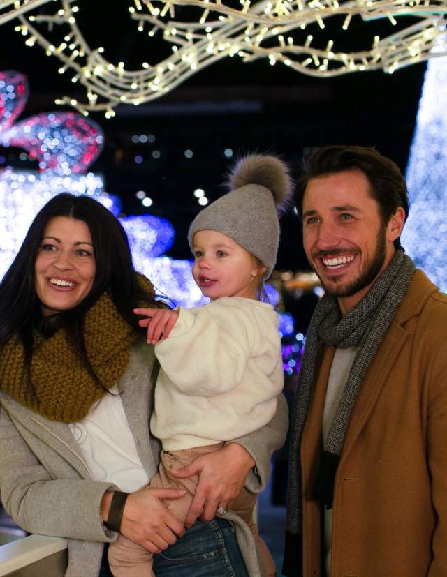 family enjoying Christmas lights