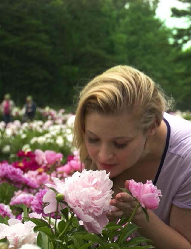 Woman smelling a peony