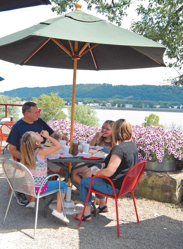 A family eats lunch at a local restaurant overlooking a river.