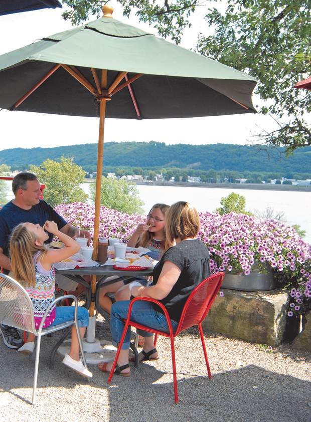 A family eats lunch at a local restaurant overlooking a river.