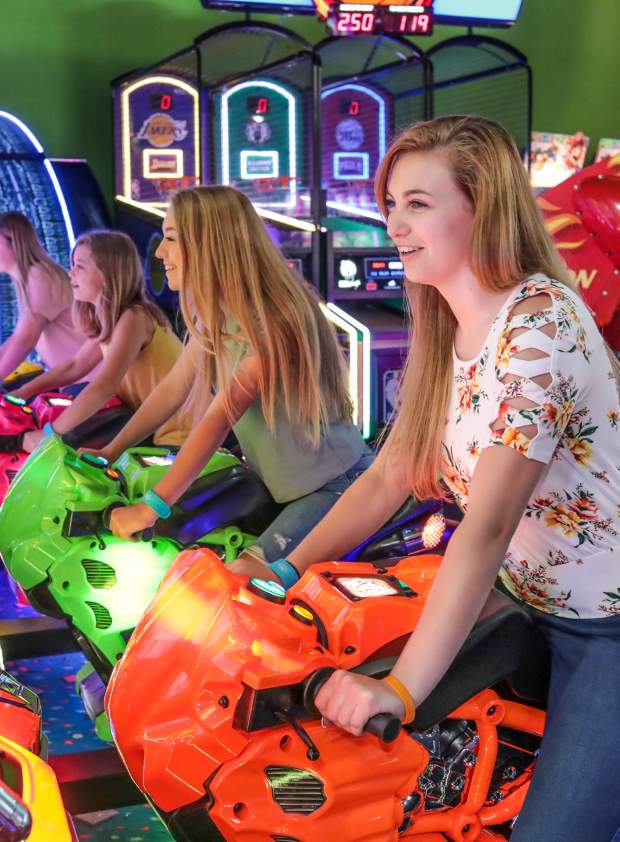 A group of young people enjoying Carlisle Sports Emporium's indoor arcade.